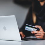 A woman entering her debit card details while transacting online
