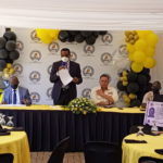 Four male officials at a press conference
